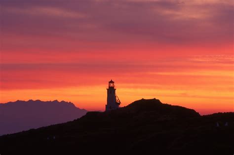 Edit free photo of Sunrise,lighthouse,dawn,silhouettes,mountains ...