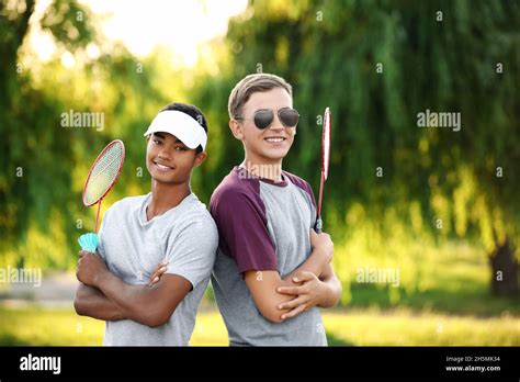 Male badminton players in park Stock Photo - Alamy