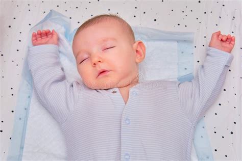 A Baby Boy Sleeps In A Cocoon On A Cot A Newborn Baby In A Diaper Is Lying Naked On The Bed