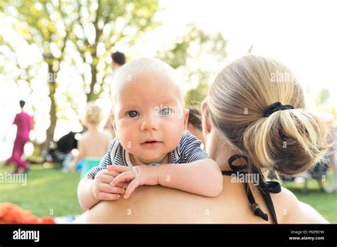 Baby Looking Over The Shoulder Of The Mother Stock Photo Alamy