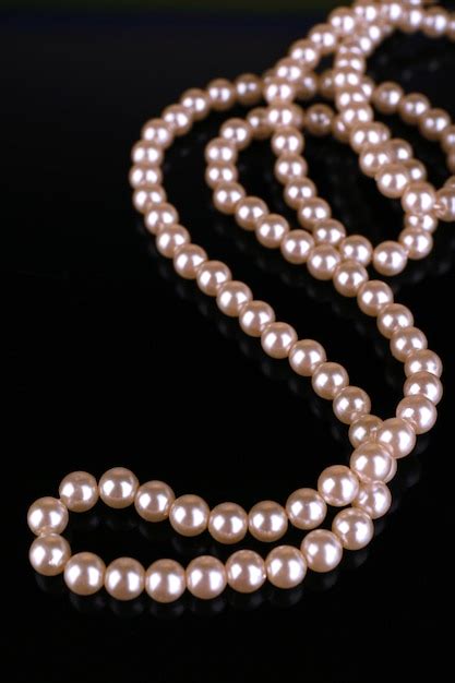 Premium Photo | Beautiful pearls on black background