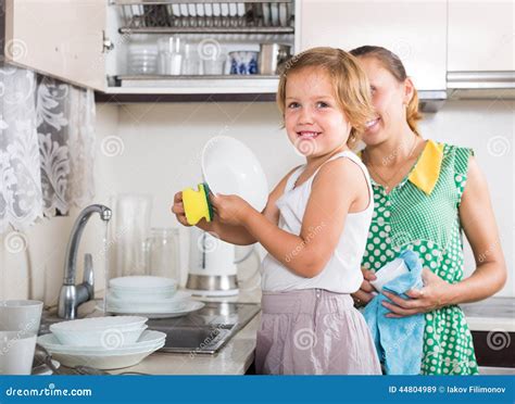 Girl Helping Mother Washing Dishes Stock Image Image Of Kitchen