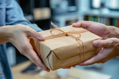 Premium Photo Close Up Of A Hand Giving A Gift Box Giving And