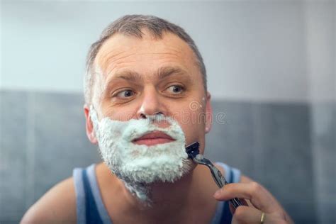 Mature Man Shaving In Front Of Mirror Stock Image Image Of Aged