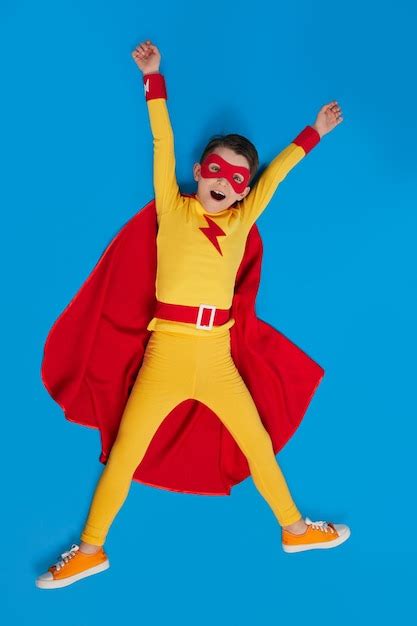 Premium Photo Cheerful Superhero Child In Costume In Studio