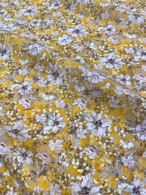 A Bed With Yellow And White Flowers On It