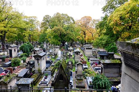 All Saints Day In Montmartre Cemetery With Autumnal Fallen Leaves