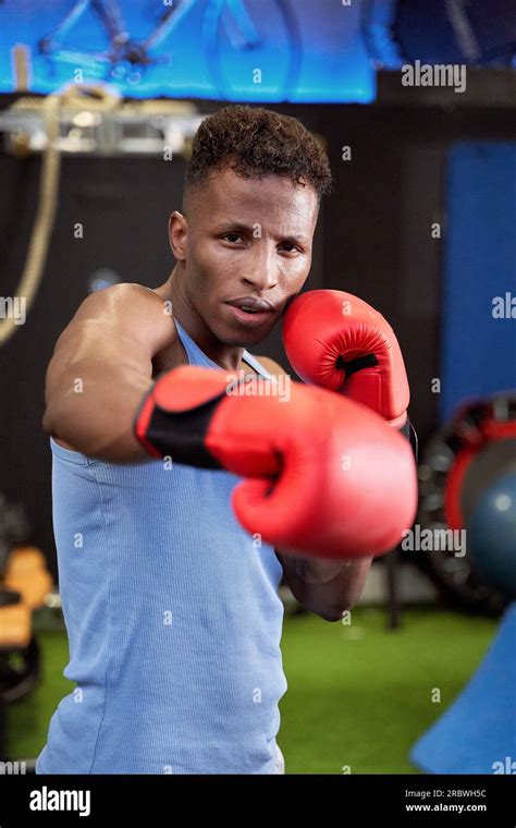 Powerful Black Male Boxer Throwing A Punch With Gloves Demonstrating