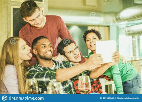 Group Of Cheerful Friends Taking Selfie Photo With Tablet In Wine Bar