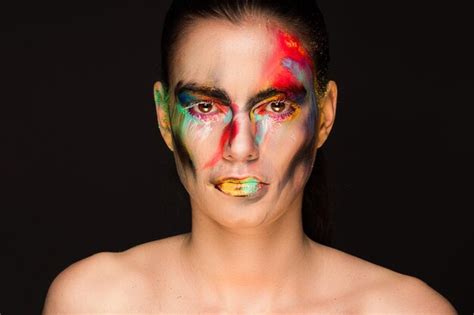 Premium Photo Portrait Of Woman With Face Paint Against Black Background