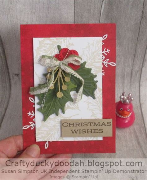 A Handmade Christmas Card With Holly And Mist