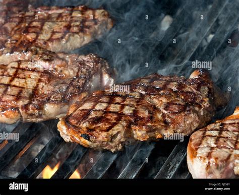 beef steak cooking on an open flame grill Stock Photo - Alamy