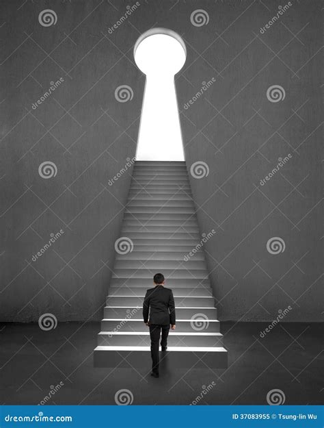 Businessman Climbing On Stair To Key Shape Door Concrete Background