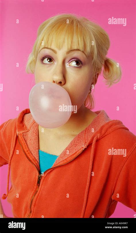 Portrait Of A Young Woman Blowing Bubble Gum Stock Photo Alamy