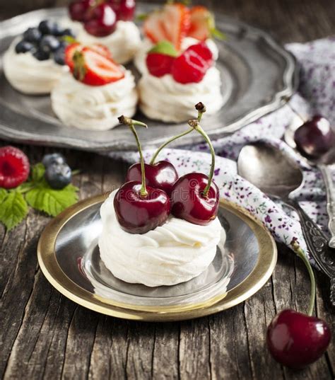 Meringue Nests Topped With Whipped Cream With Berries Stock Image