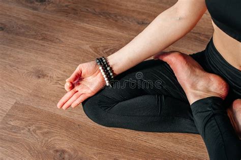 Young Woman Practicing Yoga With Namaste Behind The Back Sitting In