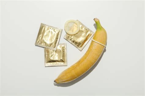 Premium Photo A Condom On A Banana On A Light Background