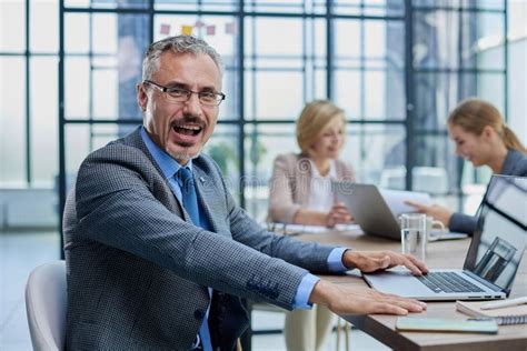 Happy Businessman Wearing Eyeglasses Sitting With Laptop Stock Image