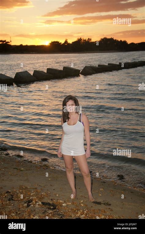 Schöne Mädchen am Strand bei Sonnenuntergang trägt einen Bikini und Weste Stockfotografie Alamy