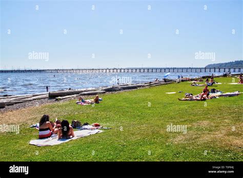 WHITE ROCK Canada - JUL 23, 2010: Visitors resting along popular White ...