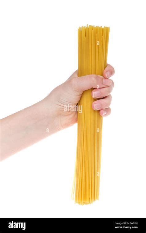 Young female hand holding dry spaghetti pasta isolated on white ...