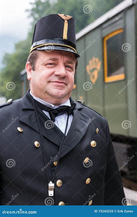 Conductor In Uniform Walking Past A Retro Poppy Line Steam Train At ...