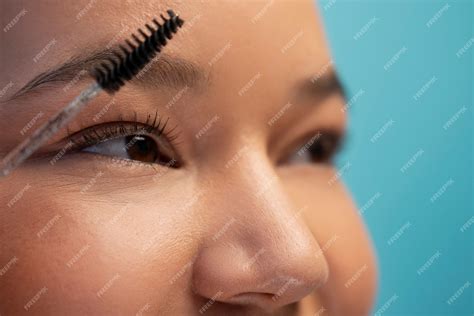 Free Photo Portrait Of Woman Using Eyebrow Brush