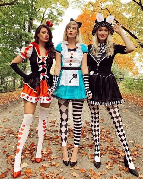 Three Women Dressed In Costumes Posing For The Camera