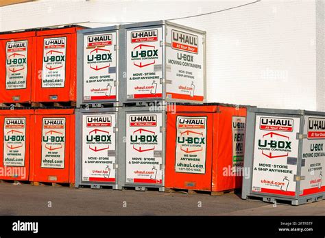 U Haul rental U Box moving containers, shipping containers stacked against a wall Stock Photo ...