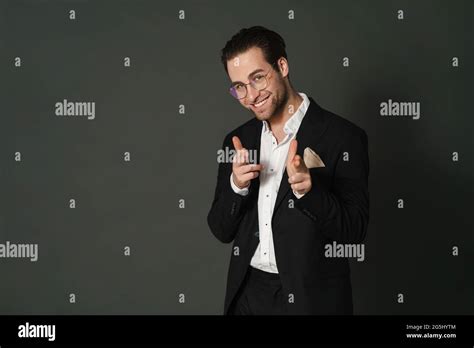Unshaven Brunette Man Smiling And Pointing Fingers At Camera Isolated