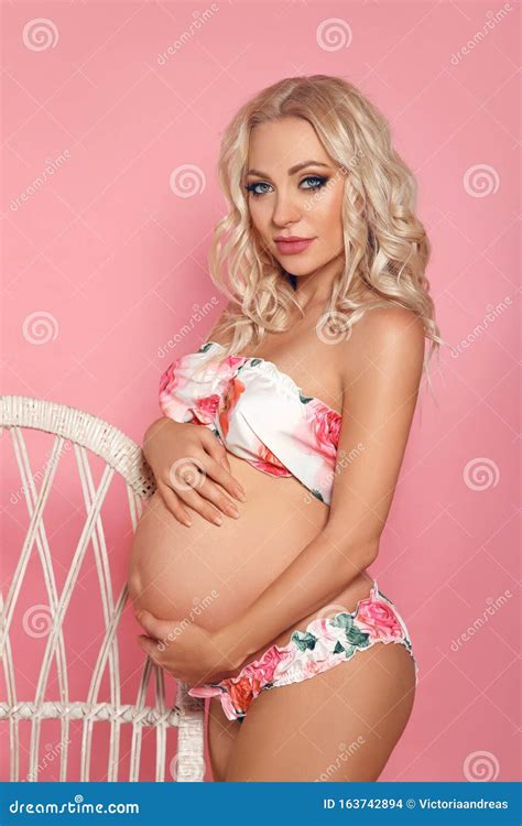 Happy Beautiful Blond Pregnant Woman Expecting Maternity Hugging Her