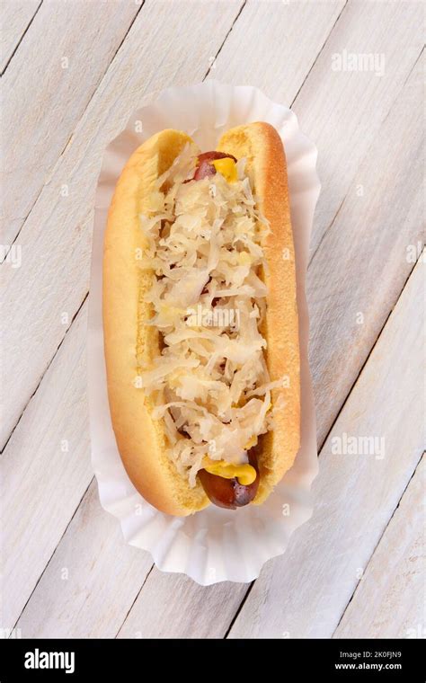 High angle shot of a Kraut Dog. A grilled hot dog on a bun with mustard ...