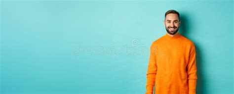 Lifestyle Handsome Man In Orange Sweater Smiling At Camera Happy Face