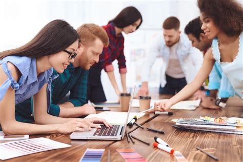 Grupo De Jóvenes Trabajan En Equipo En Una Gran Oficina Brillante