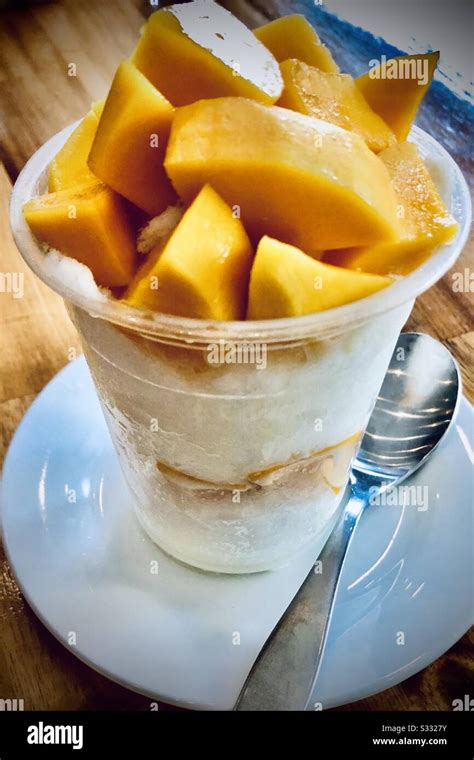 Bingsu Korean Shaved Ice Cup With Freshly Cut Mango Topping Served In