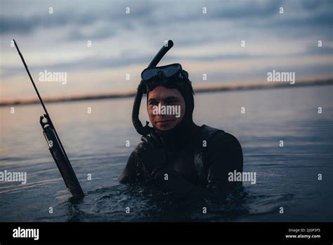 Happy Young Scuba Diver Looking At The Camera While Holding A Speargun