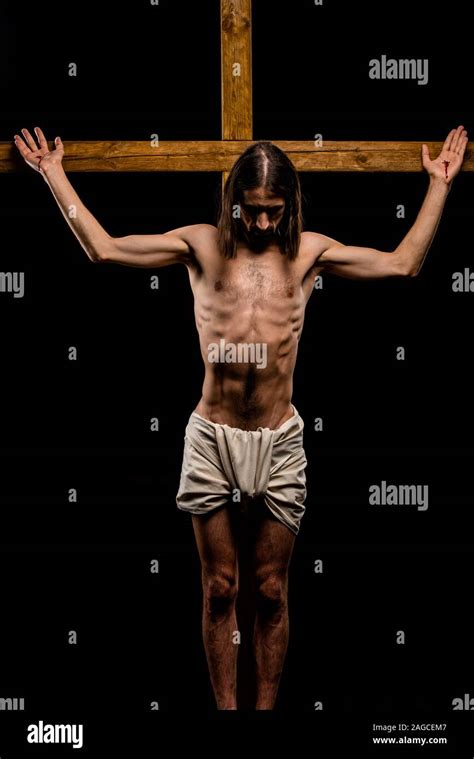 Shirtless Jesus Crucified On Wooden Cross Isolated On Black Stock Photo