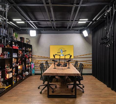 A Room With A Wooden Table Surrounded By Black Chairs And Shelves