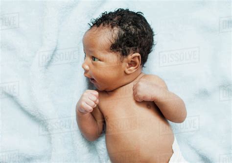 Mixed Race Newborn Baby Laying On Blanket Stock Photo Dissolve