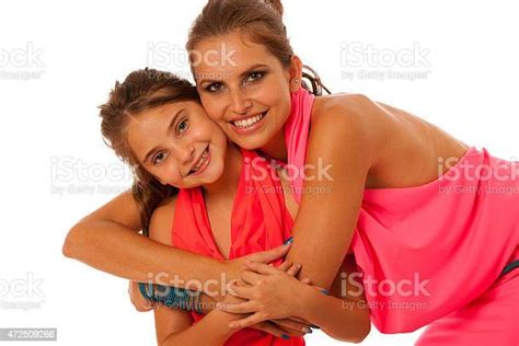 Mother Hugging Daughter Around Shoulders Isolated Over White Background