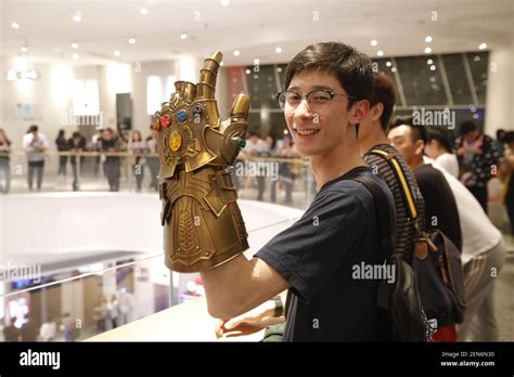 A Chinese Filmgoer Wearing The Thanos Infinity Gauntlet Waits Inside A