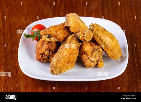 Chicken Wings Heap Served Cherry Tomato Stock Photo Alamy