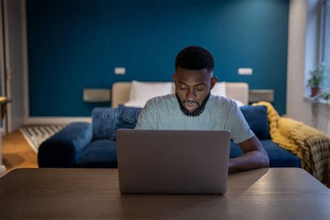 Young Focused African American Man Freelancer Working On Laptop Until