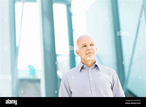 Mature Businessman Is Looking Up At A Modern Office Building