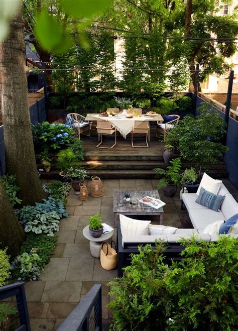 An Outdoor Patio With Tables And Chairs Surrounded By Trees