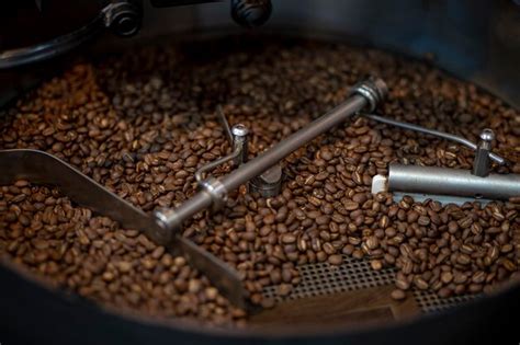 Premium Photo Coffee Beans During The Roasting Process