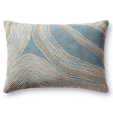 A Blue And Gold Pillow With Wavy Lines On The Front Along With A White