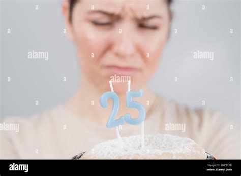 The Unhappy Woman Is Holding A Cake With Candles For Her 25th Birthday