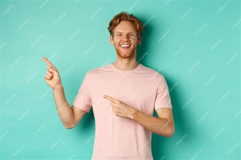 Free Photo Attractive Caucasian Man In T Shirt Pointing Fingers Left