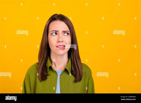 Photo Of Doubtful Sad Young Lady Wear Green Shirt Biting Lip Looking